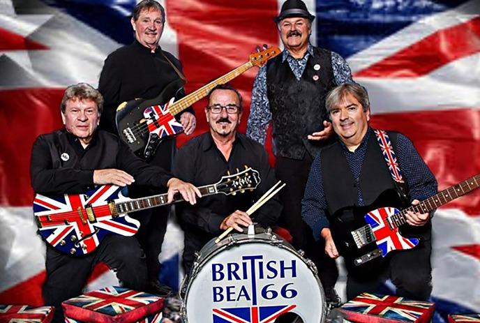 Five band members with their instruments in front of a red phone booth.
