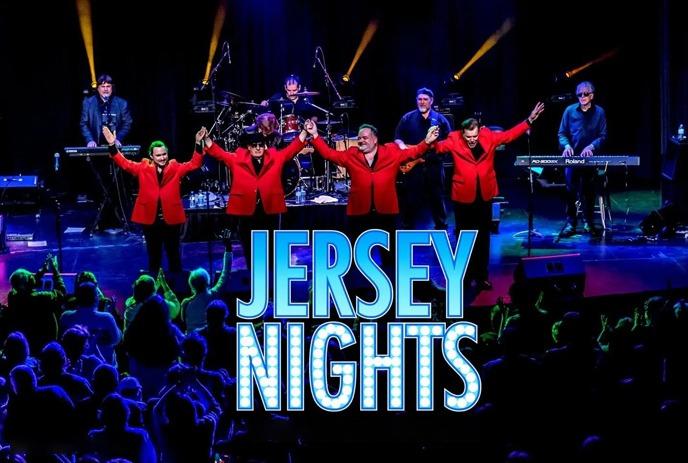 Group of men on stage dressed in blue and black and performing.