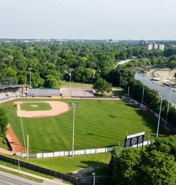 Aerial view of an outdoor park with baseball diamond and Blackfriars Bridge in London, Ontario, Canada.