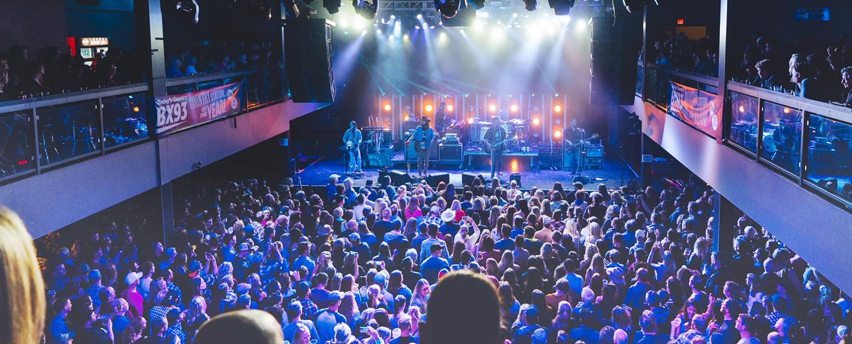 artists playing to a venue full of people