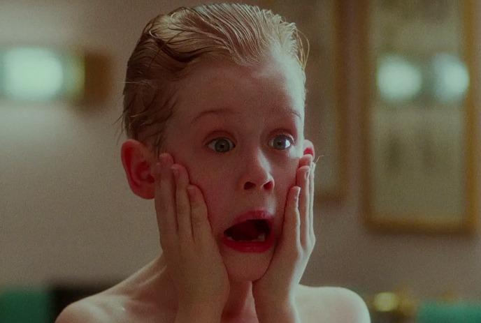 Young boy reacts hilariously after splashing his face with after shave.