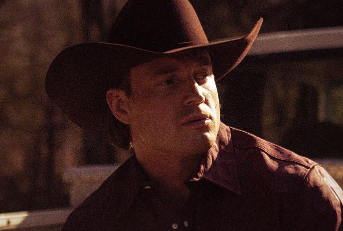 A headshot of Jade Eagleson wearing a cowboy hat and looking to the side.