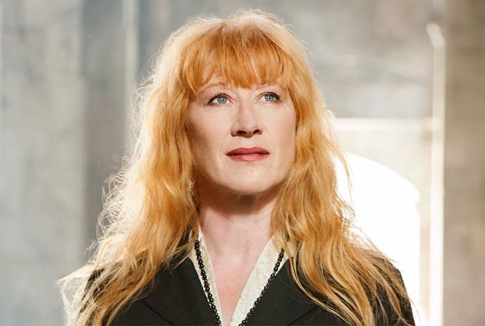 Loreena McKennitt onstage looking into the distance.