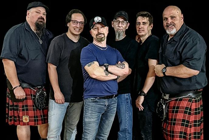 Six members of the group stand together for a photo.