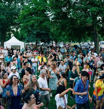 A large group of people gathered for an outdoor festival in London, Ontario