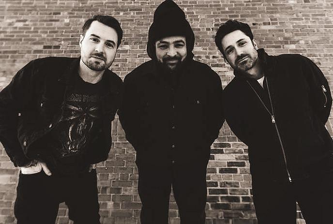 A black and white photo of Texas King performing in front of an audience in a smoky room.
